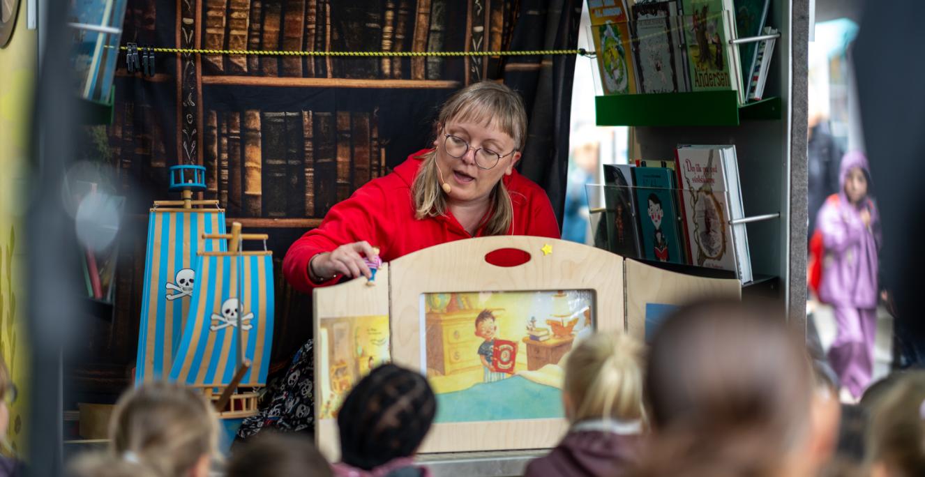 Bibliotekar Mette Laustsen fra Dansk Centralbibliotek for Sydslesvig stod for højtlæsningen ved bogbussen på Kulturmødet Mors i 2024.